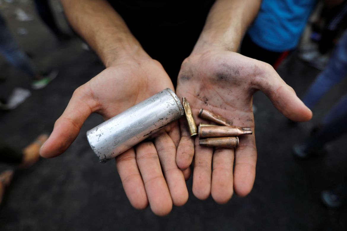 A demonstrator shows empty canisters that were used by Iraqi security forces during a protest over unemployment, corruption and poor public services, in Baghdad, Iraq October 2, 2019. REUTERS/Thaier a