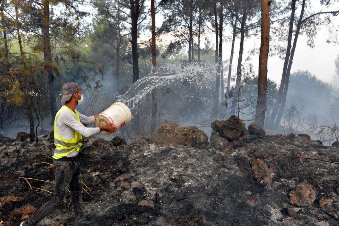 A man tries to extinguish a fire in Mechref area south Beirut, Lebanon, 15 October 2019. According to reports, 18 Lebanese people were admitted to hospitals for treatment following multiple wildfires