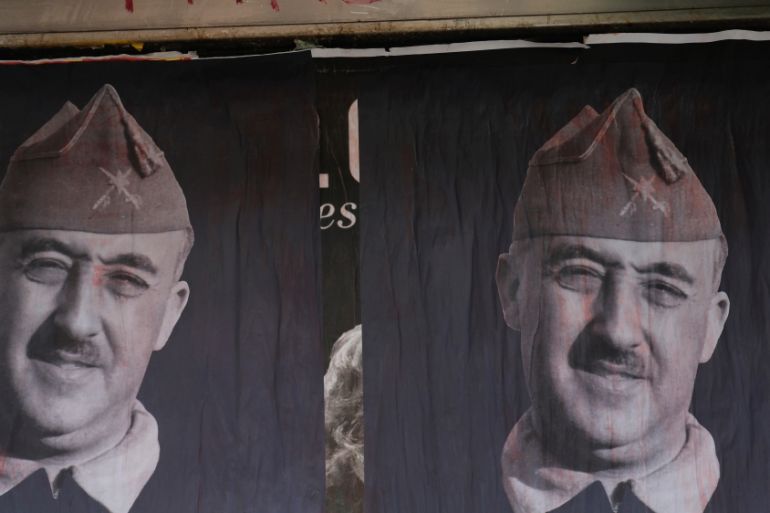 Banners of Spanish late dictator Francisco Franco are seen on a street the day before his exhumation in Madrid