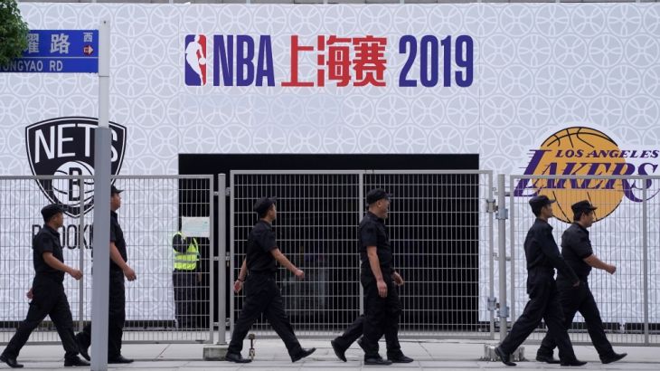 Security personnel walk past the venue that was scheduled to hold fan events ahead of an NBA China game