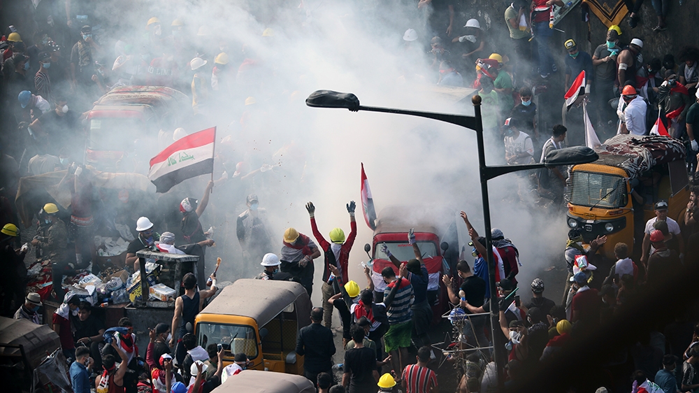 Iraqi security forces use tear gas to disperse anti-government protesters in Baghdad, Iraq, Wednesday, Oct. 30, 2019. (AP Photo/Hadi Mizban)