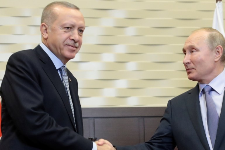 Russian President Vladimir Putin shakes hands with Turkish President Recep Tayyip Erdogan during their meeting in the Black sea resort of Sochi