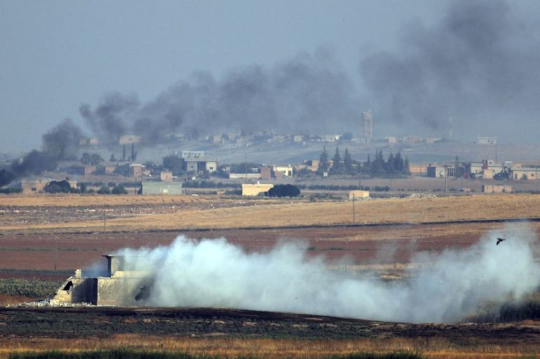 In this photo taken from the Turkish side of the border between Turkey and Syria, in Akcakale, Sanliurfa province, southeastern Turkey, smoke billows from targets inside Syria during bombardment