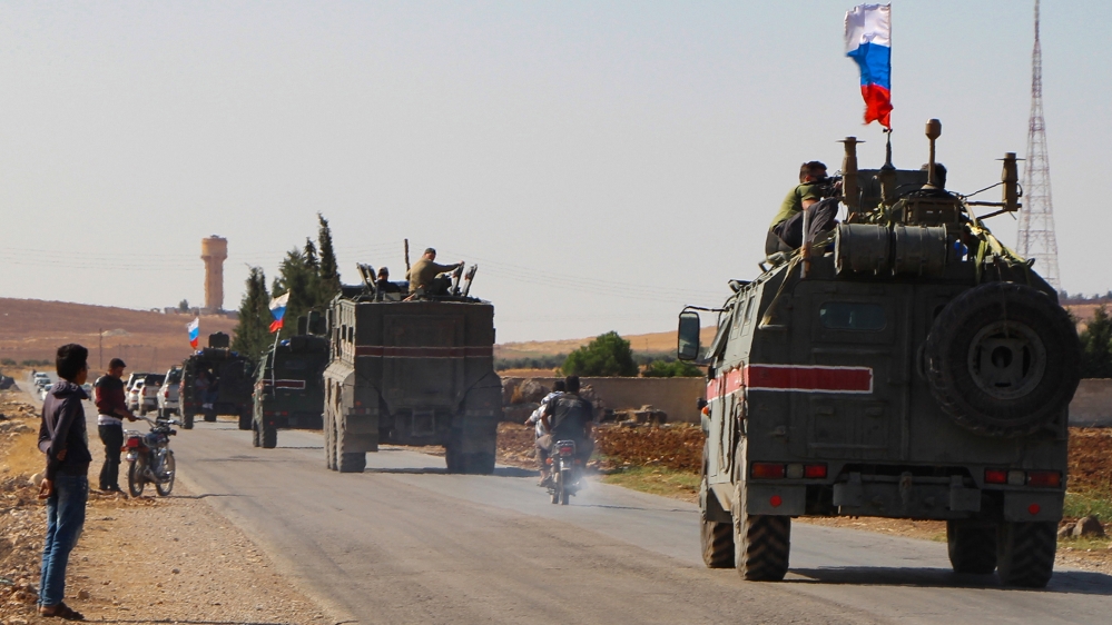A convoy of Russian military vehicles drives toward the northeastern Syrian city of Kobane on October 23, 2019. Russian forces in Syria headed for the border with Turkey today to ensure Kurdish fighte