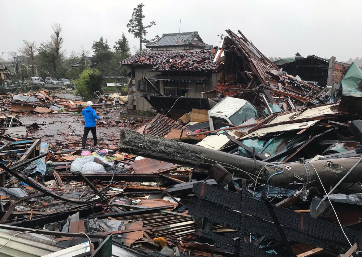 A man walks through debris of damaged houses by a tornado caused by typhoon Hagibis in Ichihara, Chiba Prefecture, east of Tokyo, 12 October 2019. Tyhoon Hagibis is expected to make landfall on the Pa