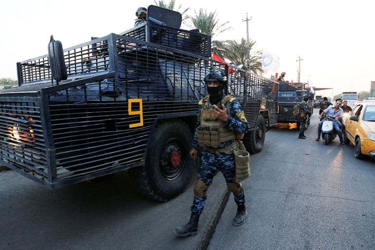 A member of the Iraqi federal police is seen near military vehicles in a street in Baghdad, Iraq October 7, 2019. REUTERS/Wissm al-Okili