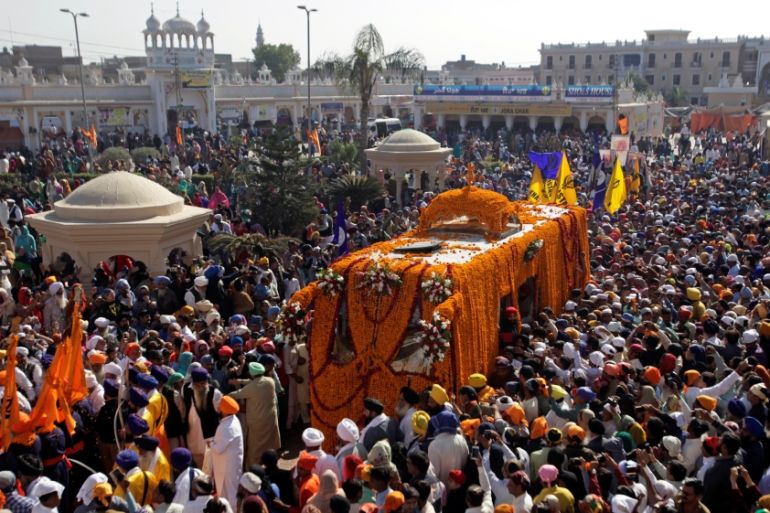 Sikh devotees attend a religious procession to mark the 549th birth anniversary of Guru Nanak Dev Ji, founder of Sikhism, in Nankana Sahib near Lahore