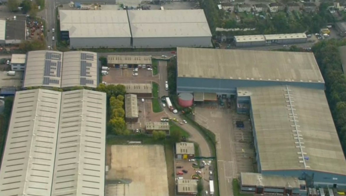 An aerial view as police forensic officers attend the scene after a truck, seen at centre, was found to contain a large number of dead bodies, in Thurrock, South England, Wednesday Oct. 23, 2019. Poli