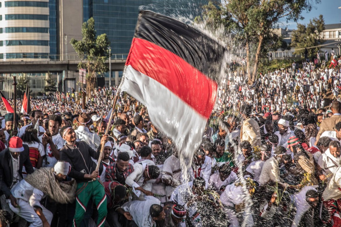 A man waves a flag as people from community of Oromo from different parts of Ethiopia gather at Meskel square in Addis Ababa, on October 5, 2019 on the eve of Irreecha, their thanksgiving festival tha