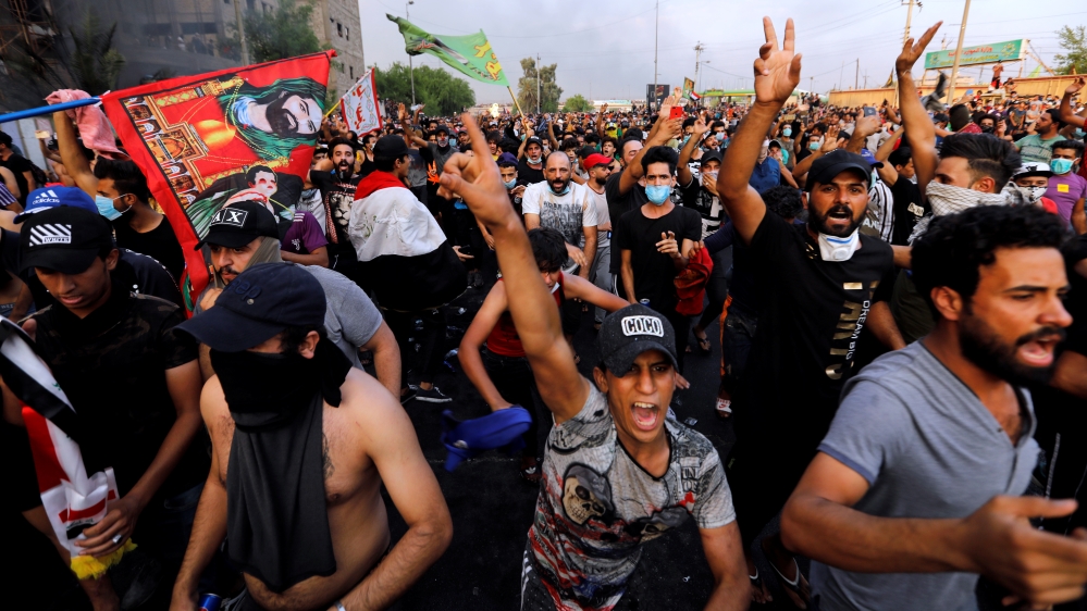 Demonstrators gesture at a protest over unemployment, corruption and poor public services, in Baghdad