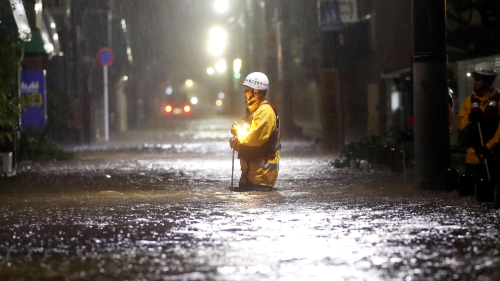 Firefighters patrol on a flooded road due to heavy rains caused by Typhoon Hagibis at Ota ward in Tokyo, Japan