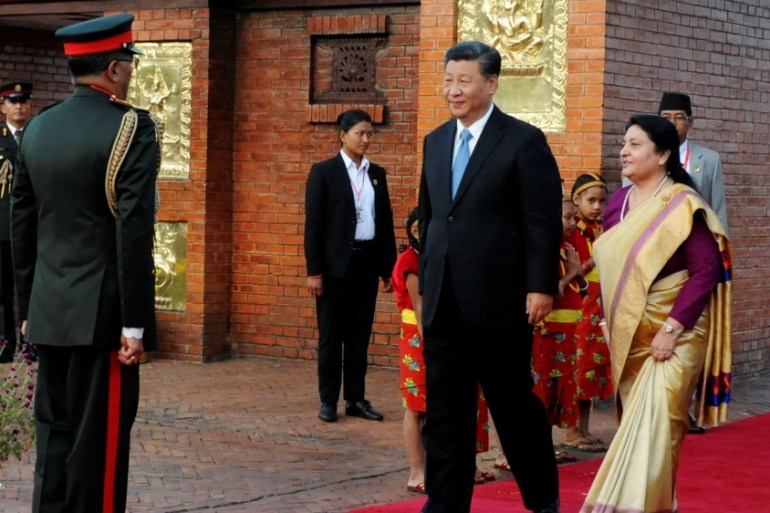 Nepal''s President Bidhya Devi Bhandari walks with China''s President Xi Jinping during a welcome ceremony at the Tribhuvan International Airport in Kathmandu