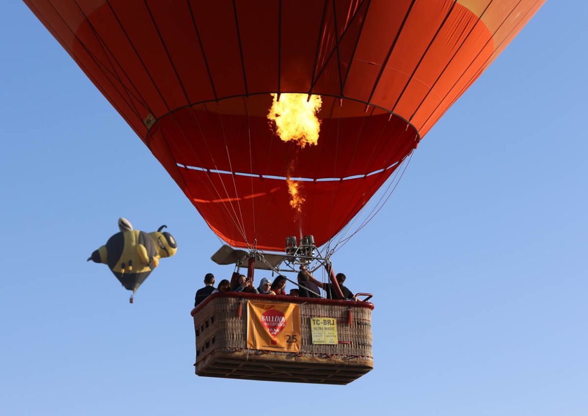Hot air balloons featuring various figures fly over charming touristic hub famed for its fairy chimneys in Turkey as part of the International Cappadocia Hot Air Balloon Festival on July 06, 2019 in N