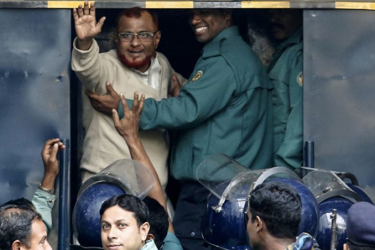 Bangladesh Jamaat-e-Islami Assistant Secretary General ATM Azharul Islam looks on as he is taken to the prison van after the verdict by the International Crimes Tribunal (ICT)-1 in Dhaka, Bangladesh,