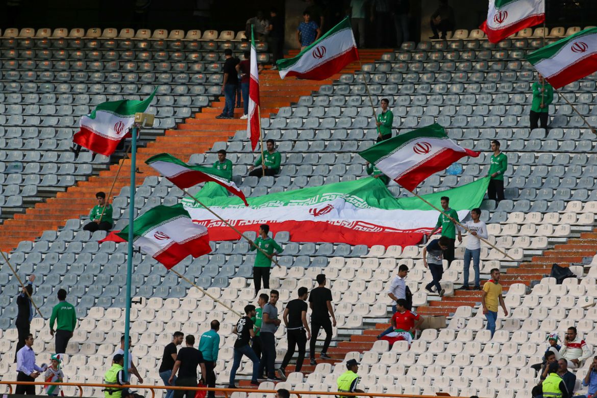 Iranian fans wave their country''s national flags during the World Cup Qatar 2022 Group C qualification football match between Iran and Cambodia at the Azadi stadium in the capital Tehran on October 10