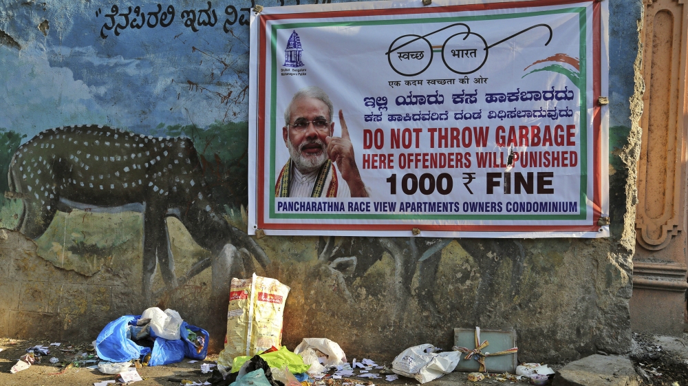 Garbage lies under a banner that reads 