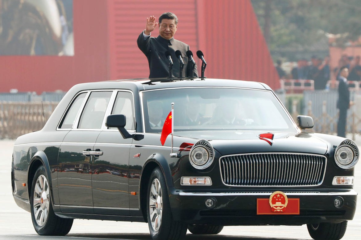 Chinese President Xi Jinping waves from a vehicle as he reviews the troops at a military parade marking the 70th founding anniversary of People''s Republic of China, on its National Day in Beijing, Chi