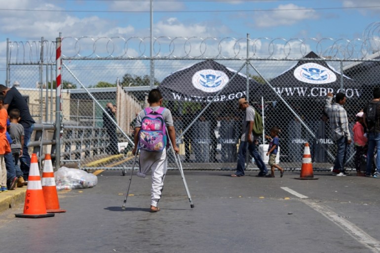 A group of migrants block the Puerta Mexico international border crossing bridge in Matamoros