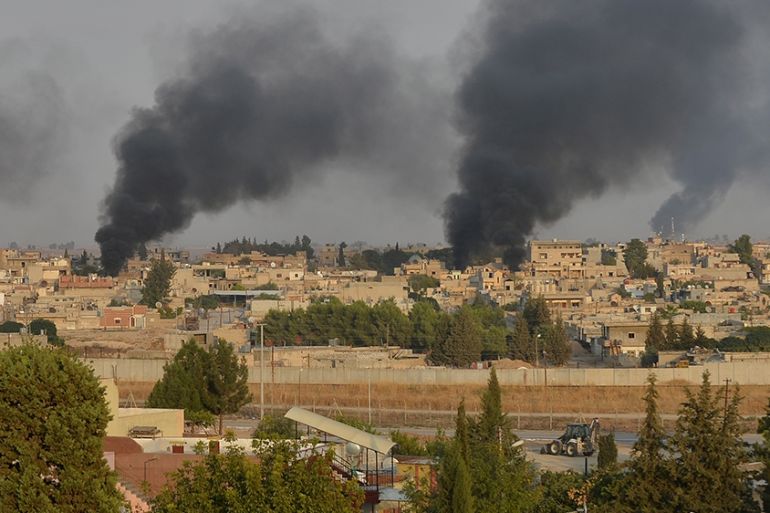 Smoke rises from the Syrian border town of Ras al-Ain as it is pictured from the Turkish town of Ceylanpinar in Sanliurfa province, Turkey, October 9, 2019. REUTERS/Stringer NO RESALES. NO ARCHIVES T