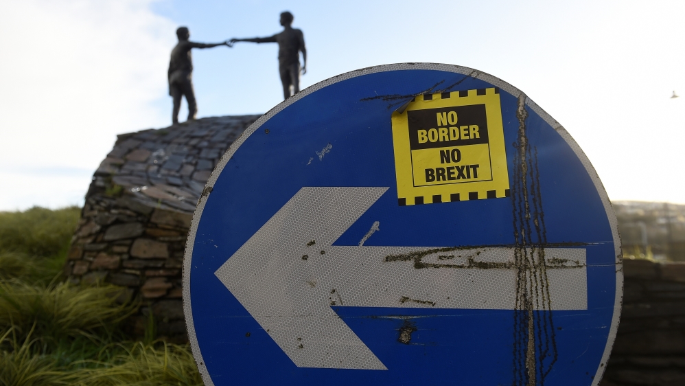 A ' No Border, No Brexit' sticker is seen on a road sign in front of the Peace statue entitled 'Hands Across the Divide' in Londonderry, Northern Ireland, January 22, 2019