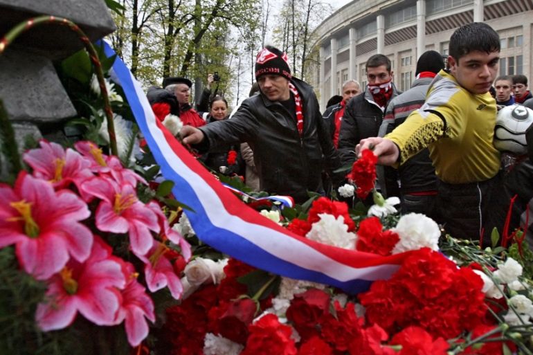 Russian soccer fans and players lay flowers at a memorial to the 66 fans that tragically died in a post-match jam near the exit of Luzhniki stadium in Moscow, 20 October 2007. The tragedy happened 25