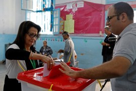 Woman casts her ballot at a polling station during parliamentary elections, in Tunis