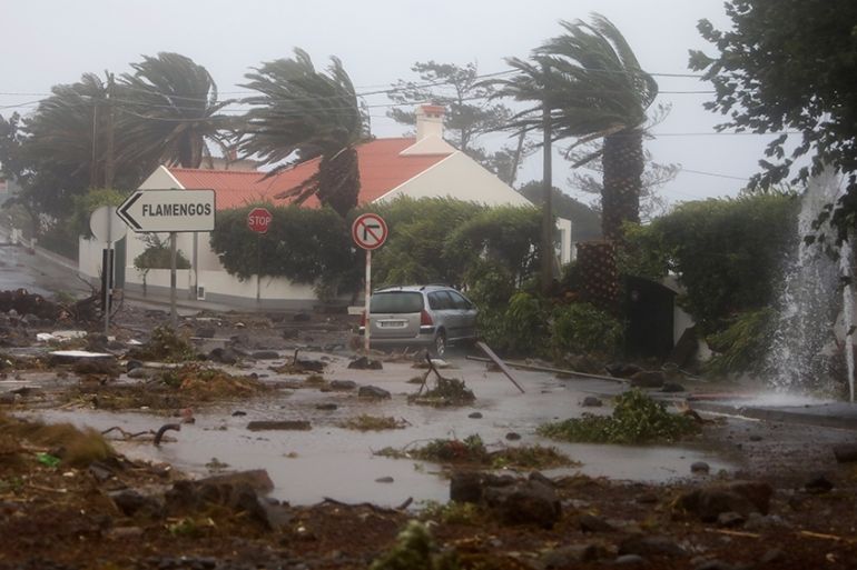 Debris blocks a road in the seafront village of Feteira, outside Horta, in the Portuguese island of Faial, Wednesday, Oct. 2, 2019. Hurricane Lorenzo is lashing the mid-Atlantic Azores Islands with he