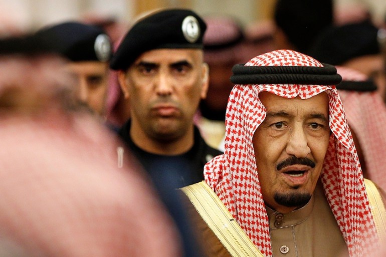 FILE - In this Jan. 24, 2015 file photo, Saudi Arabia''s King Salman is guarded by his bodyguard Maj. Gen. Abdulaziz al-Fagham, back ground, as he attends a ceremony at the Diwan royal palace in Riyadh