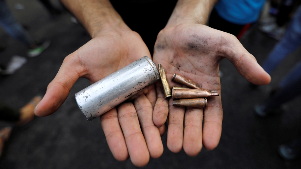 A demonstrator shows empty canisters that were used by Iraqi security forces during a protest over unemployment, corruption and poor public services, in Baghdad, Iraq October 2, 2019.