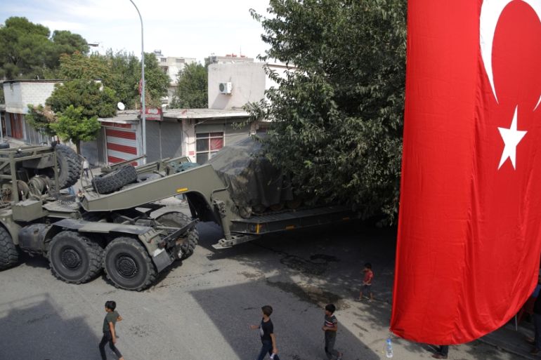 Turkish military equipment is transported on a street in the Turkish border town of Akcakale in Sanliurfa province
