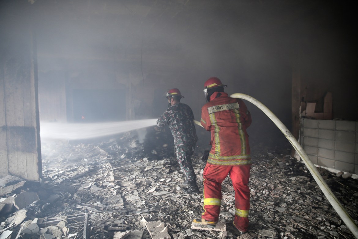Lebanese firemen extinguish a fire inside a building that was burned in a wildfire overnight, in the town of Damour just over 15km (9 miles) south of Beirut, Lebanon, Tuesday, Oct. 15, 2019. Strong fi