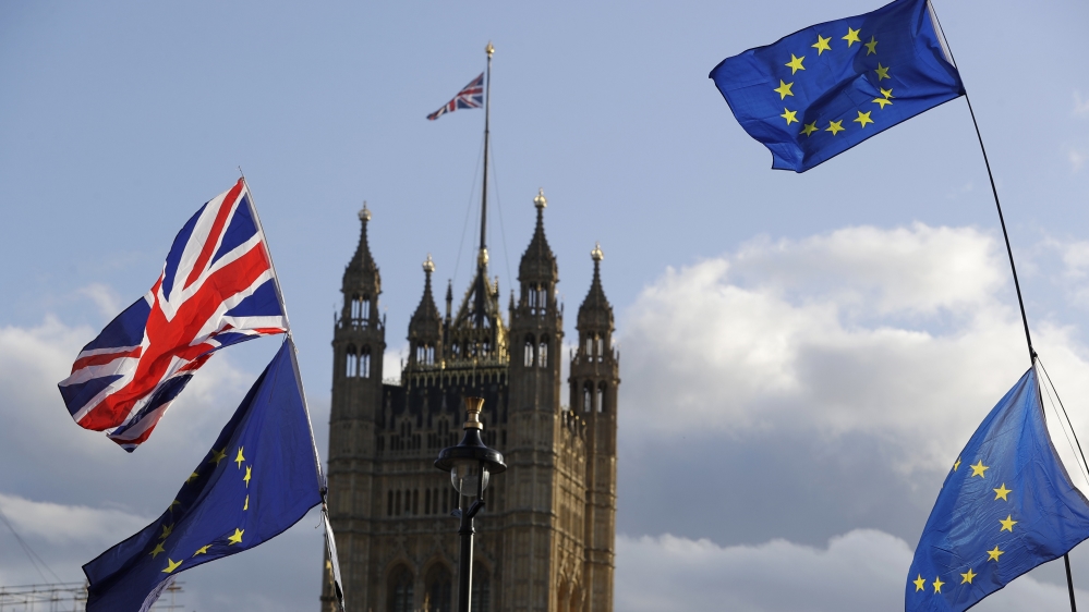 Union Jacks and EU flags fly over Britain's Parliament in London, Saturday, Oct. 19, 2019