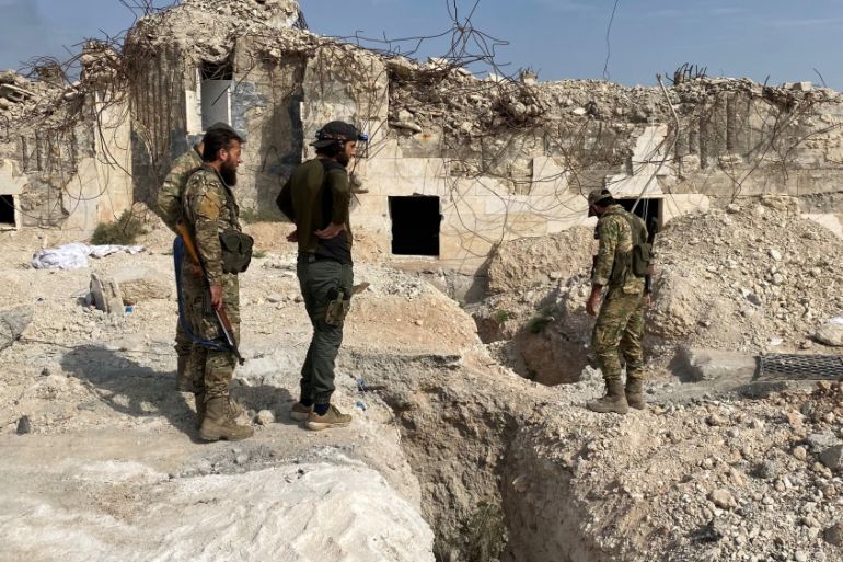 Turkey-backed Syrian rebel fighters stand near underground tunnels said to be made by the Syrian Democratic Forces (SDF) in Tal Abyad