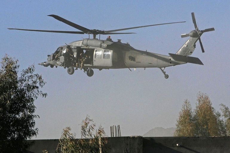 A U.S. helicopter flies at the site of an incident in Kandahar province February 7, 2011. A suicide bomber killed an Afghan interpreter working for U.S. forces in an attack on a customs office in Afgh
