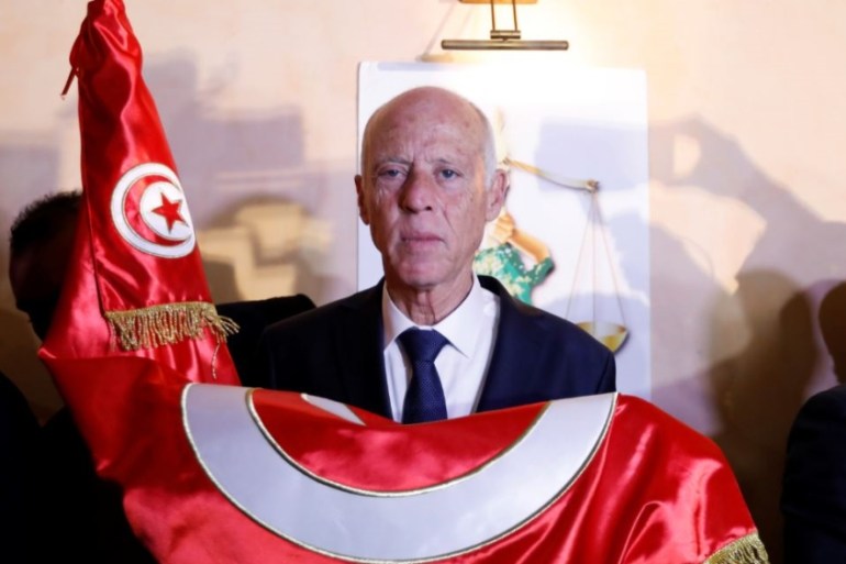 Tunisian presidential candidate Kais Saied reacts after exit poll results were announced in a second round runoff of the presidential election in Tunis