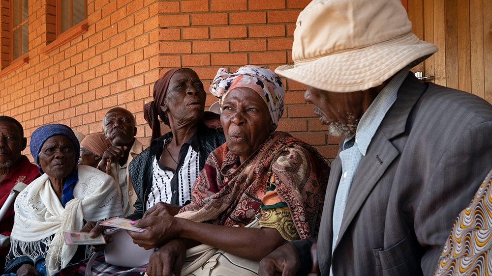 Elderly women and men wait in line to vote in Botswana's general elections in Moshupa, some 45kms (30 miles) West of Gaborone, Wednesday, Oct. 23, 2019. Botswana's ruling party the BDP (Botswana Democ