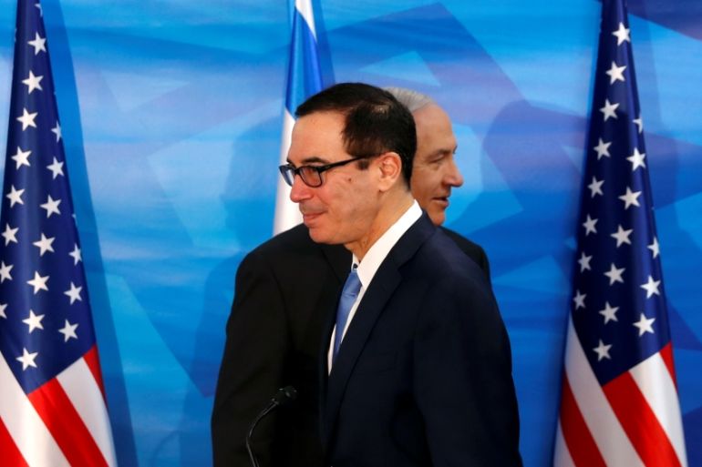 Israeli Prime Minister Benjamin Netanyahu walks behind U.S. Treasury Secretary Steven Mnuchin as they prepare to deliver joint statements during their meeting in Jerusalem