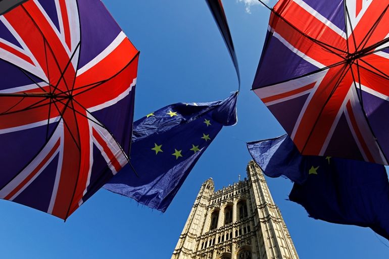 EU and Union flags belonging to both anti-Brexit and pro-Brexit activists, fly outside the Houses of Parliament in London on October 22, 2019, as MPs begin debating the second reading of the Governmen