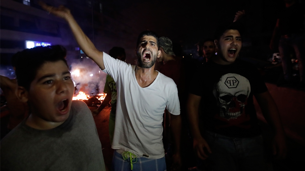 LEBANON-INTERNET-BUDGET-DEMO  Lebanese demonstrators chant slogans during a protest against recent tax calls on October 17, 2019 in the southern suburbs of Beirut. 