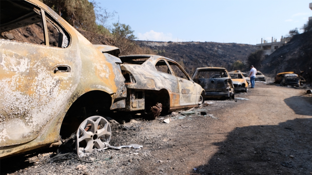 Intense fires in Lebanon’s Chouf region charred vehicles at a garage owned by Damour resident Walid Mansour [Timour Azhari/Al Jazeera]
