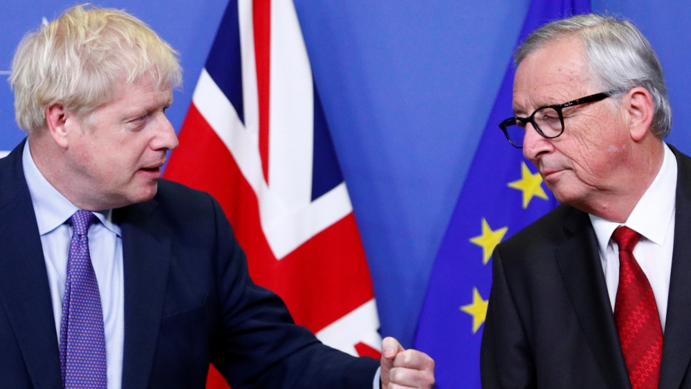 Britain's Prime Minister Boris Johnson gestures next to European Commission President Jean-Claude Juncker