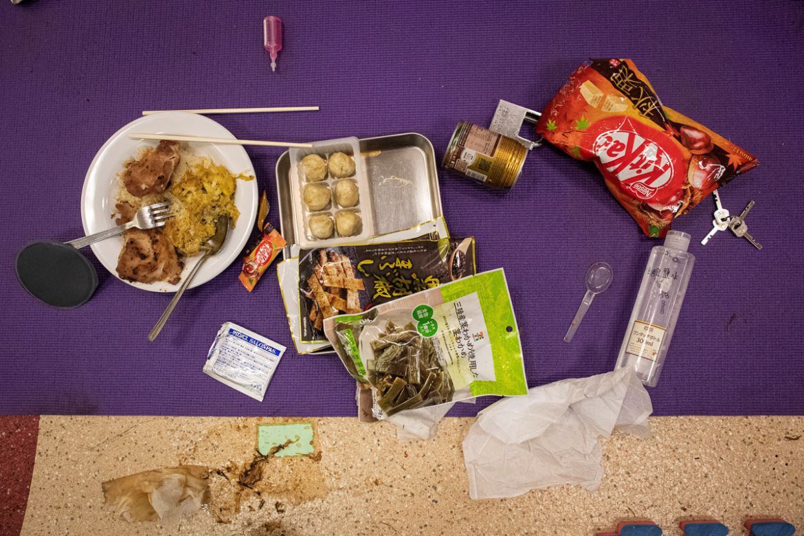 Food left over by a protester is seen on a mat on the floor inside the Hong Kong Polytechnic University in the Hung Hom district of Hong Kong on November 20, 2019. - A dwindling number of exhausted pr