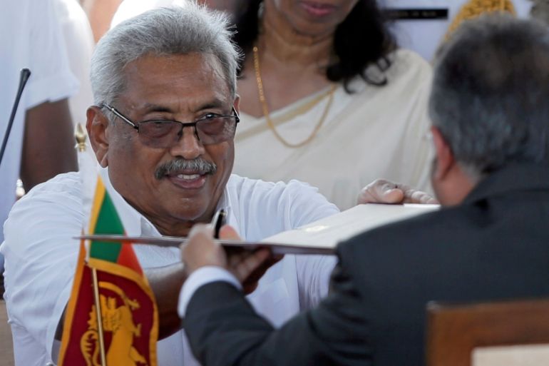Sri Lanka''s President-elect Gotabaya Rajapaksa hands over a document to Sri Lanka''s Chief Justice Jayantha Jayasuriya at the presidential swearing-in ceremony in Anuradhapura