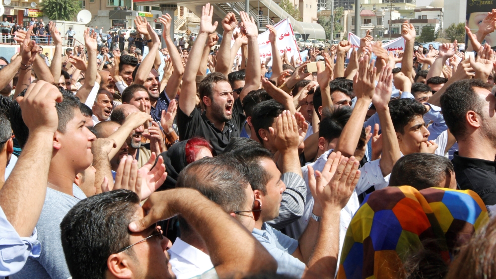 Protesters, who are mostly school teachers, demonstrate on a street in Sulaymaniyah province, Iraq, against the Kurdish regional government for what the protesters said was a delay in payment of their