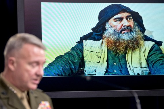 Abu Bakr al-Baghdadi is displayed on a monitor as U.S. Central Command Commander Marine Gen. Kenneth McKenzie at a joint press briefing at the Pentagon in Washington, Wednesday, Oct. 30, 2019, on the