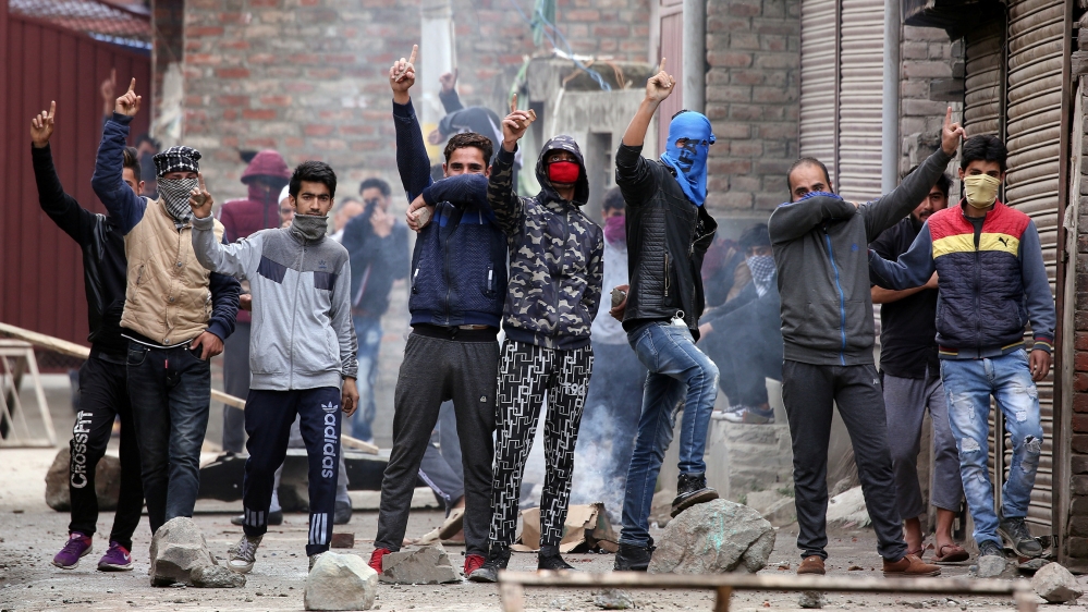 Kashmiri demonstrators react during clashes with Indian police during a protest against the killing of Zakir Rashid Bhat also known as Zakir Musa, the leader of an al Qaeda affiliated militant group i