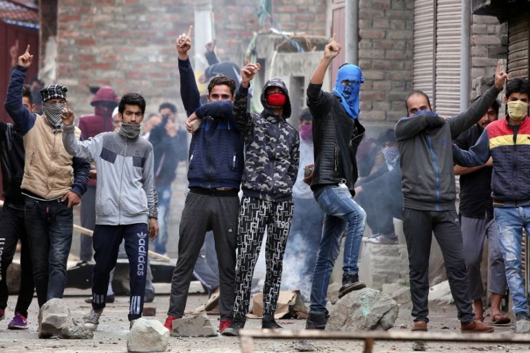 Kashmiri demonstrators react during clashes with Indian police during a protest against the killing of Zakir Rashid Bhat also known as Zakir Musa, the leader of an al Qaeda affiliated militant group i