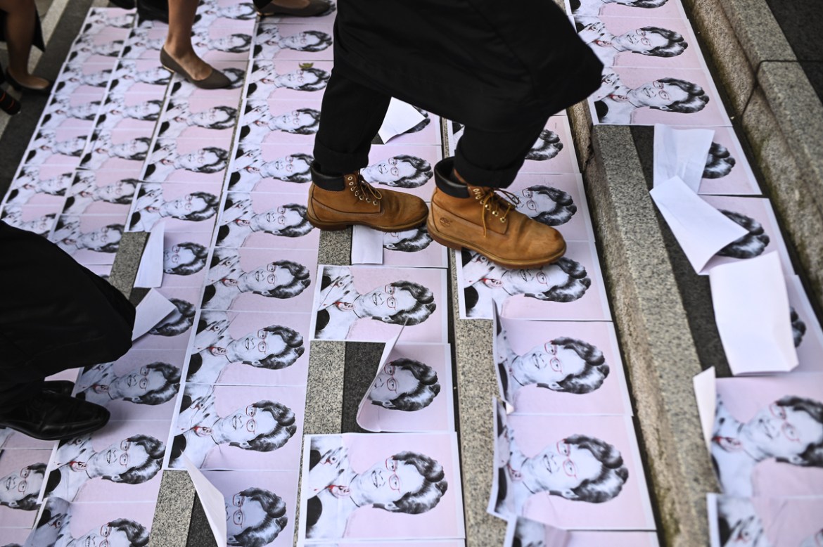 University students walk on posters of Hong Kong chief executive Carrie Lam during an anti-government protest before their graduation ceremony at the Chinese University of Hong Kong on November 7, 201