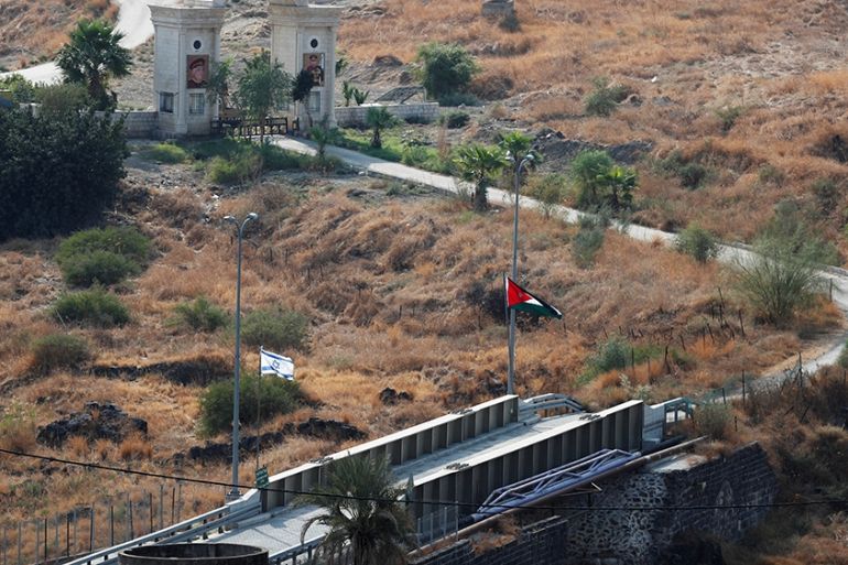 The national flags of Israel and Jordan are seen in an area known as Naharayim in Hebrew and Baquora in Arabic, in the border area between Israel and Jordan, as seen from the Israeli side November 10,