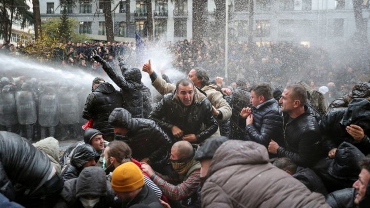 Riot police use water canon to disperse demonstrators during a protest against the government and to demand an early parliamentary election in Tbilisi